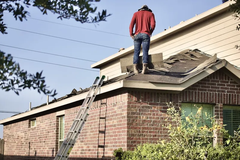 Professional roofer working on a residential roof in Stetson Valley